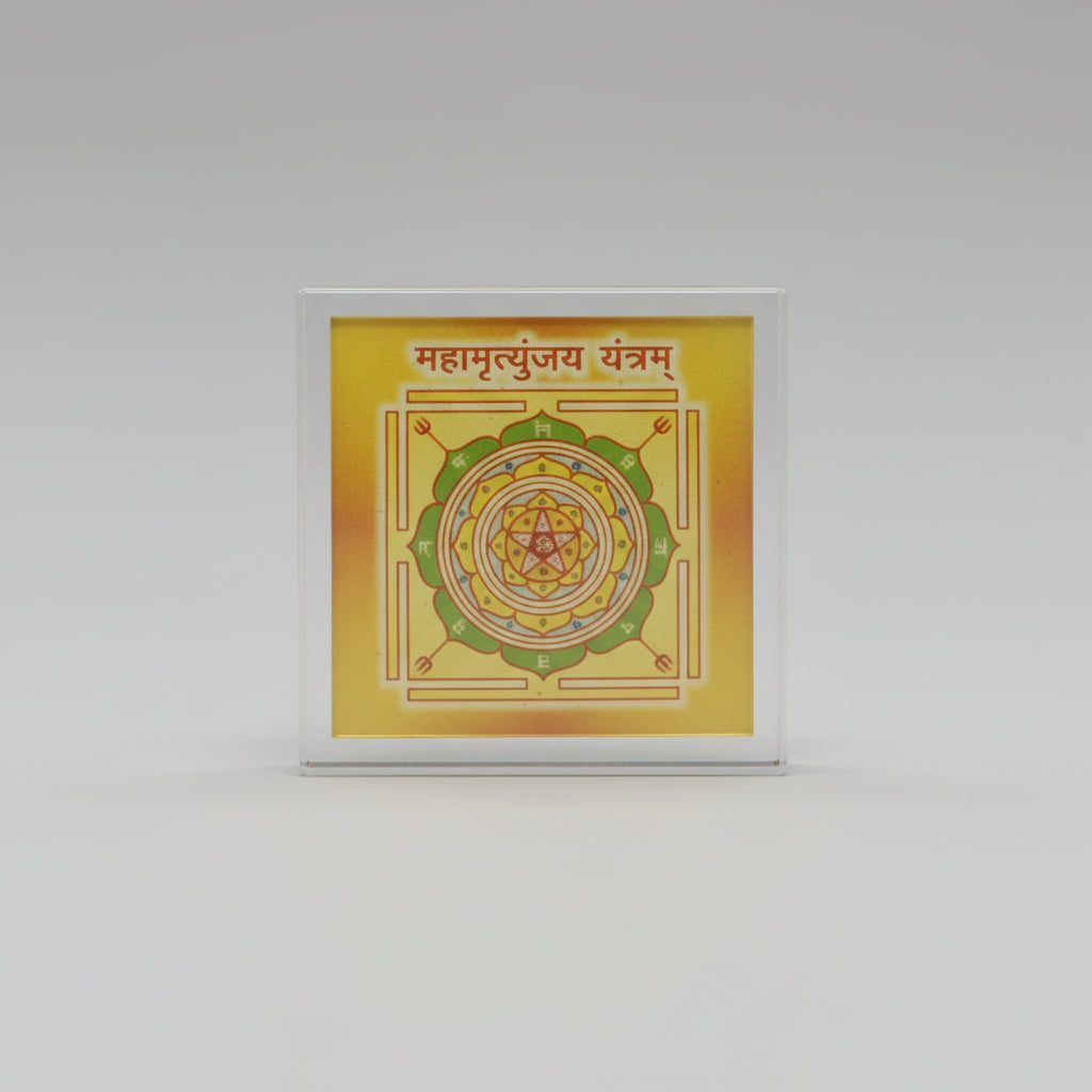 A Maha Mrityunjay Yantra, which is a spiritual protection symbol, displayed in a clear plastic cover with a yellow and green color design.