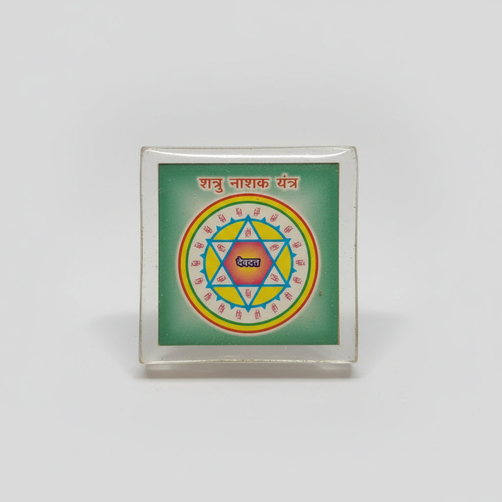 A Shatru Nashak Yantra, which is a spiritual tool used for protection and overcoming adversaries, displayed in a person's hand.