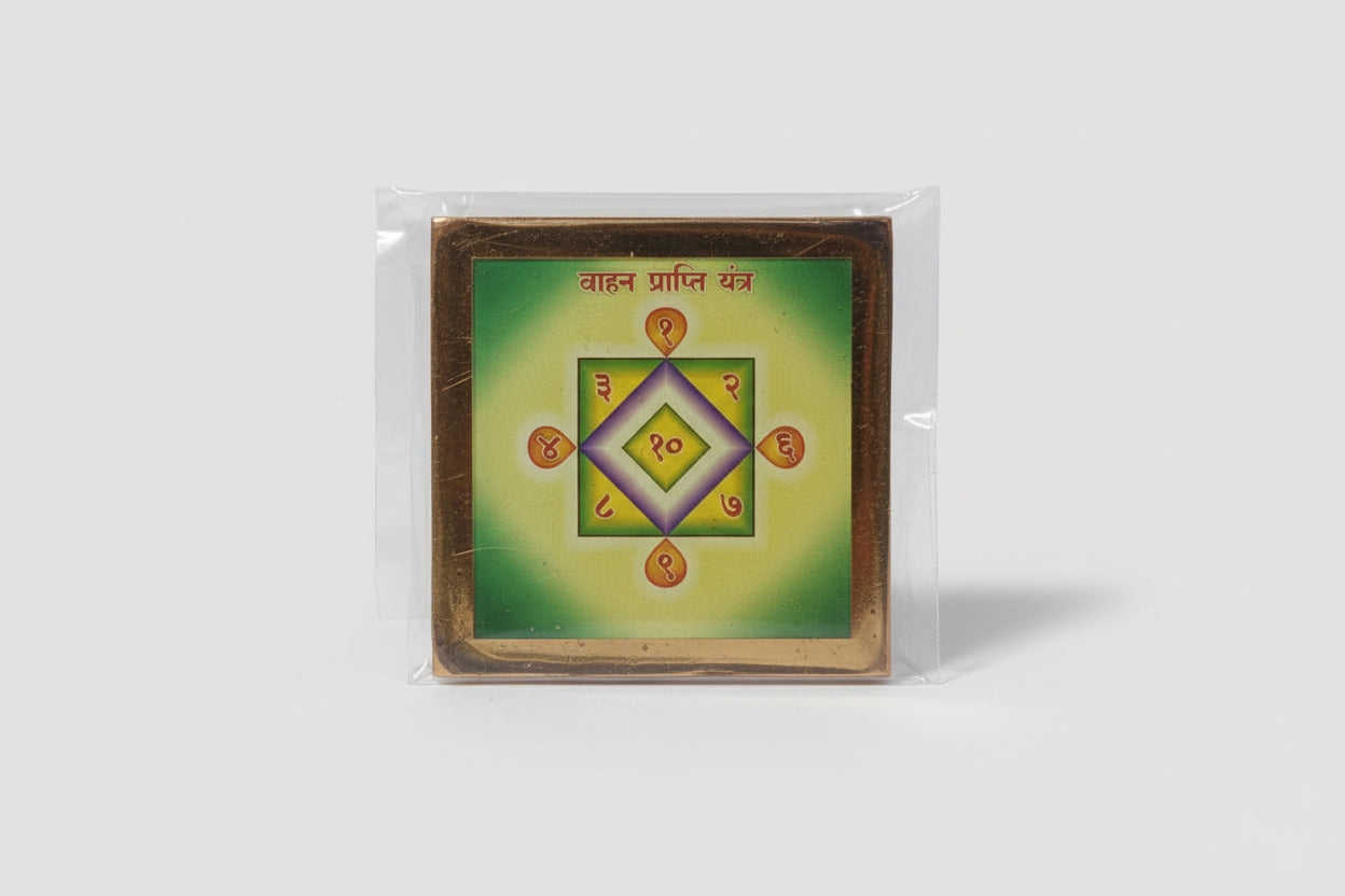 A hand holding a sacred geometric diagram yantra with green and gold colors, used for worship to assist in acquiring a vehicle.
