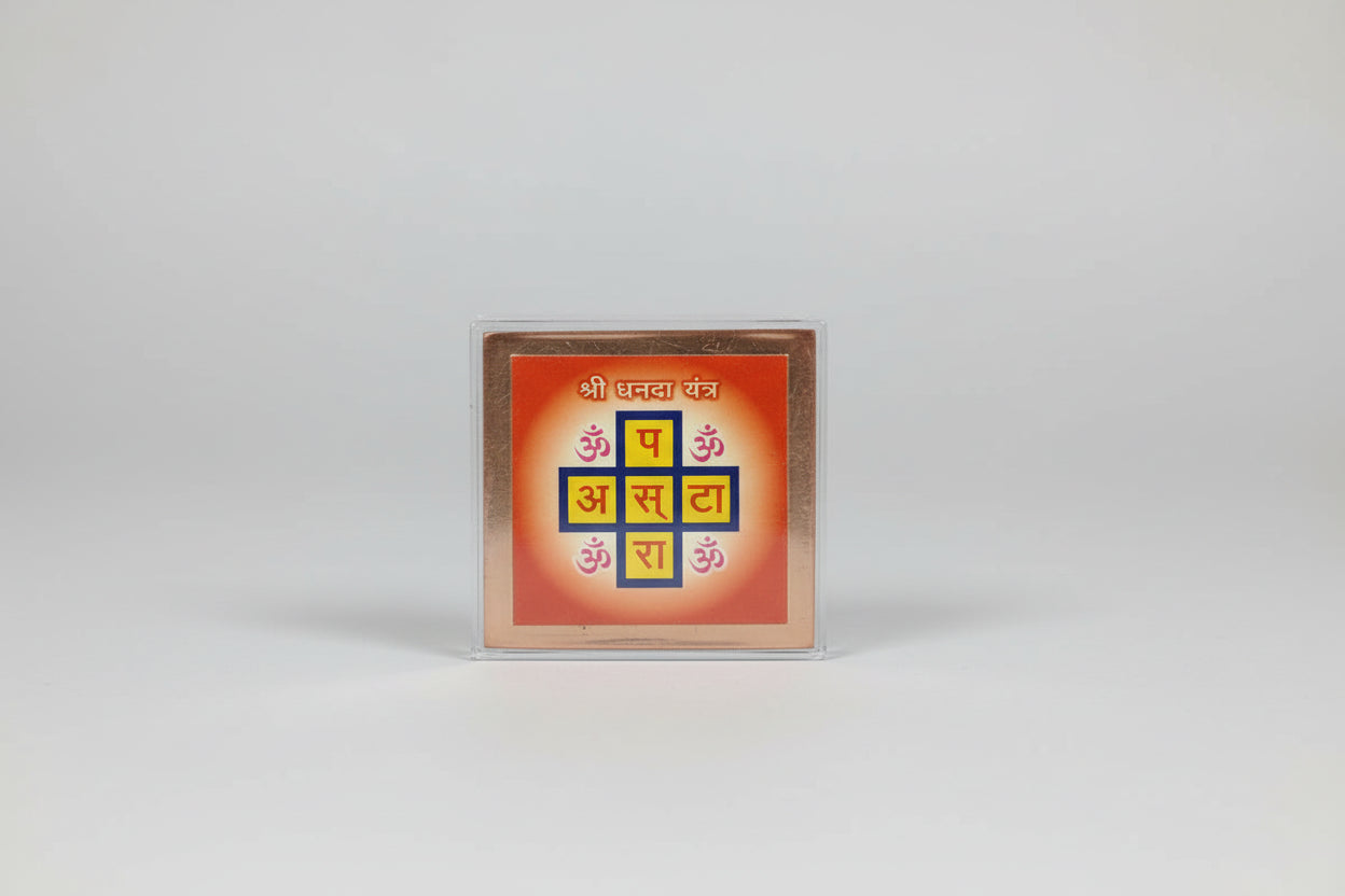 A hand holding a Shri Dhanda Yantra, which is a mystical diagram used in Hinduism to attract financial abundance.