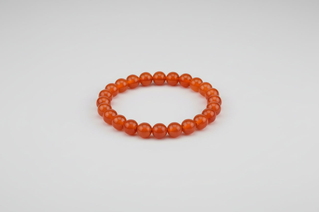 An advertisement image featuring a Carnelian bracelet with text highlighting its benefits such as enhancing fertility, creativity, and success.