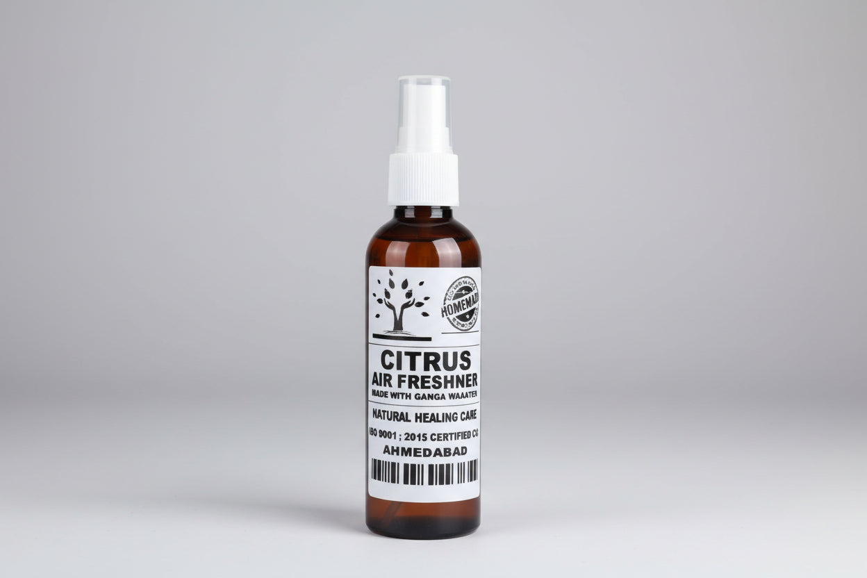A bottle of citrus air freshener with a white spray nozzle, labeled 'Citrus Air Freshener', with a background of a bathroom setting.