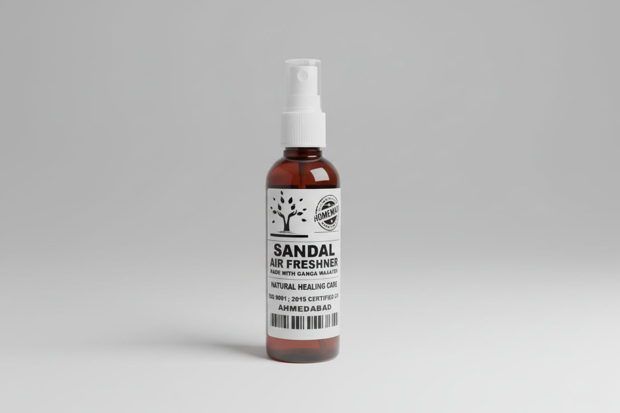 A brown bottle with a white spray nozzle labeled as 'SANDAL AIR FRESHENER' with additional text that is not clear.