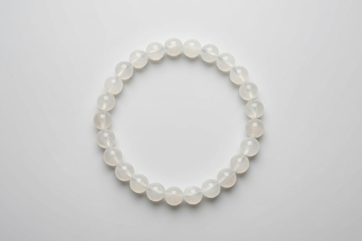 A Selenite bracelet displayed on a wooden surface with a price tag.