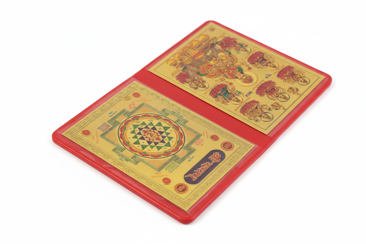 A photo of a Ashta Lakshmi Shri Yantra, with intricate golden patterns on a red background, displayed on a wooden surface.