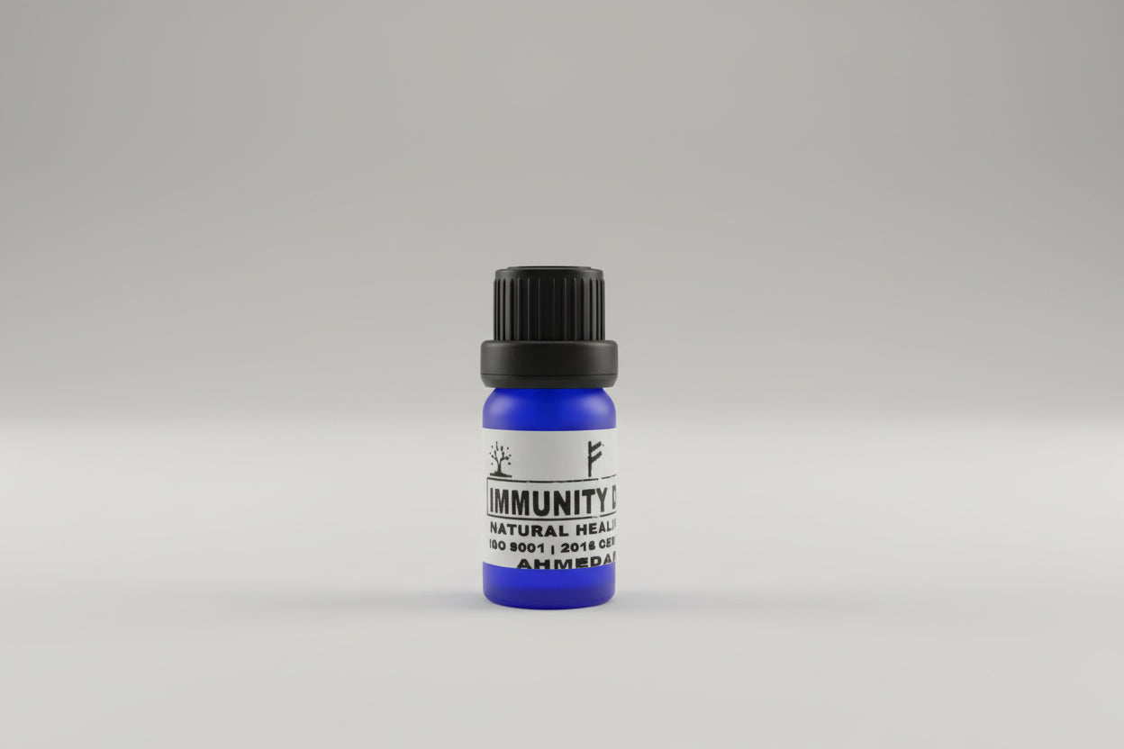 A small blue bottle with a black cap labeled 'IMMUNITY' placed on a wooden surface.