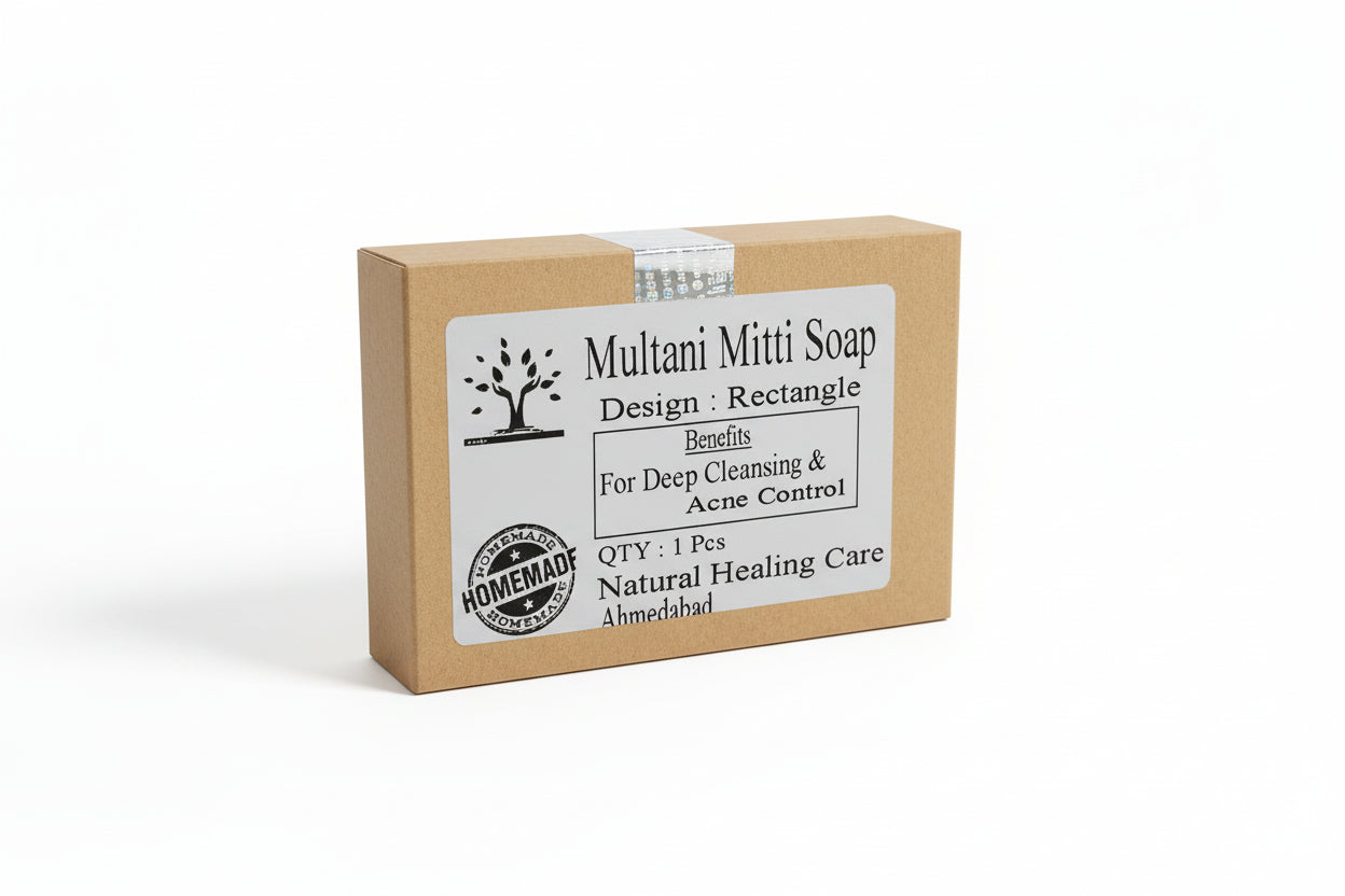 Hand holding a bar of Multani Mitti soap with a label that includes the brand name, product name, and benefits like deep cleansing and acne control.