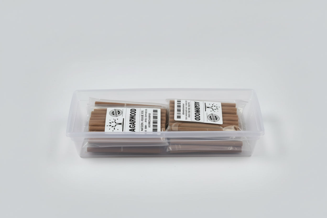 Packaged Agarwood dhoop sticks in clear plastic boxes with labels.