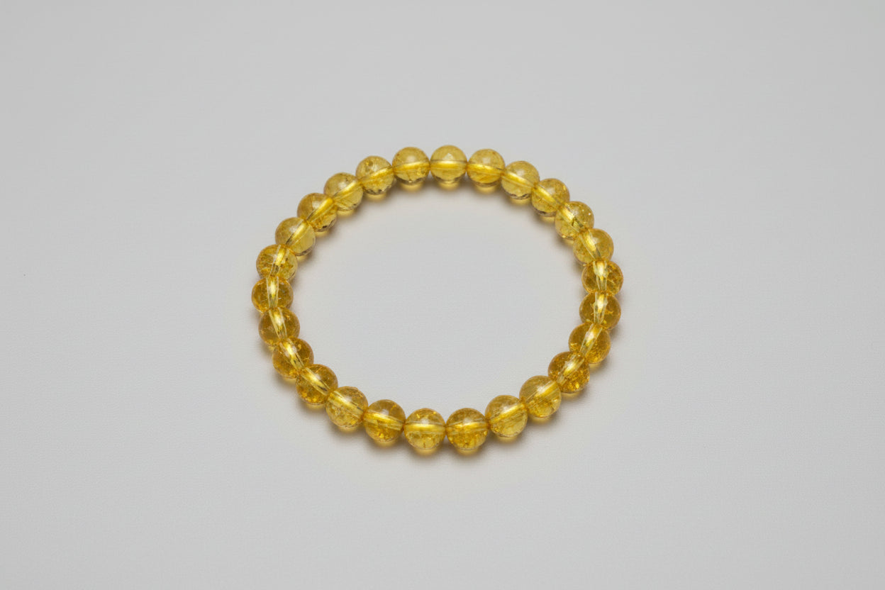 A yellow citrine bracelet displayed against a white background with text highlighting the bracelet's benefits such as success, abundance, and luck, along with the price and contact information.
