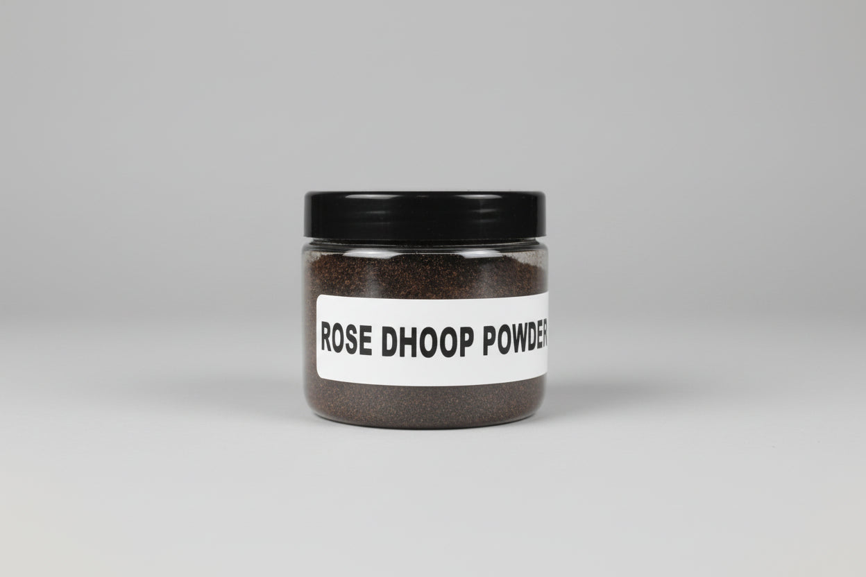 A person holding a jar labeled 'ROSE DHOOP POWDER' on a red background, with a label also showing the phone number '9586810426'.