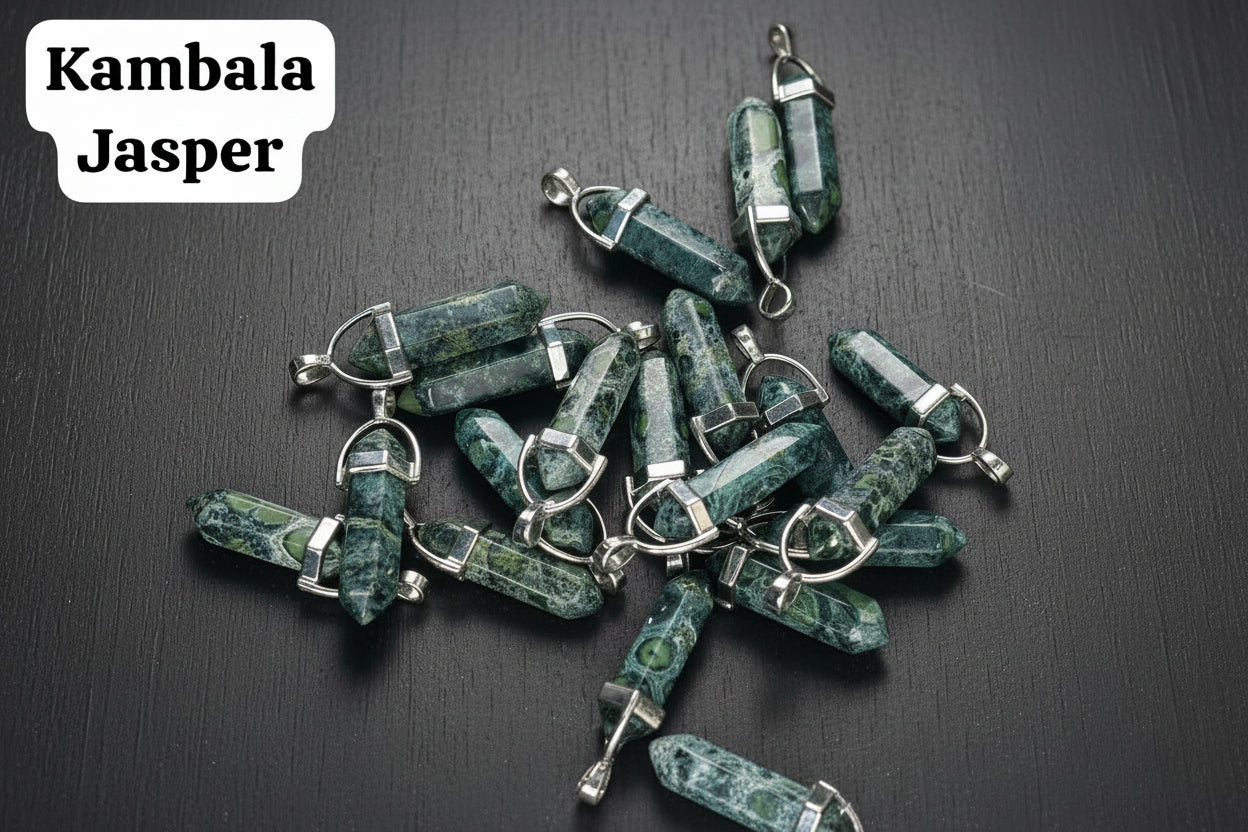 A collection of Kambala Jasper pencil-shaped pendants displayed on a textured surface.