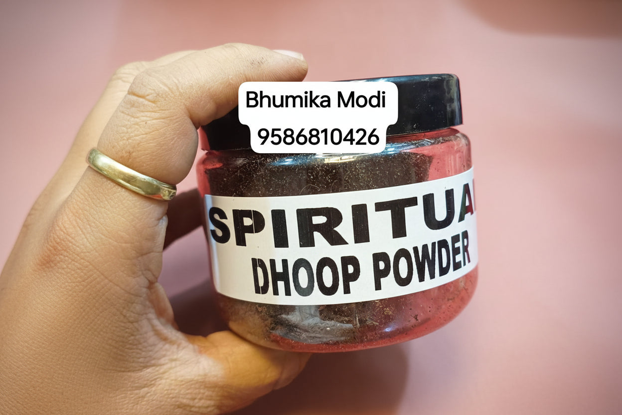 A jar labeled 'SPIRITUAL DHOOP POWDER' held in a person's hand, with a red background.