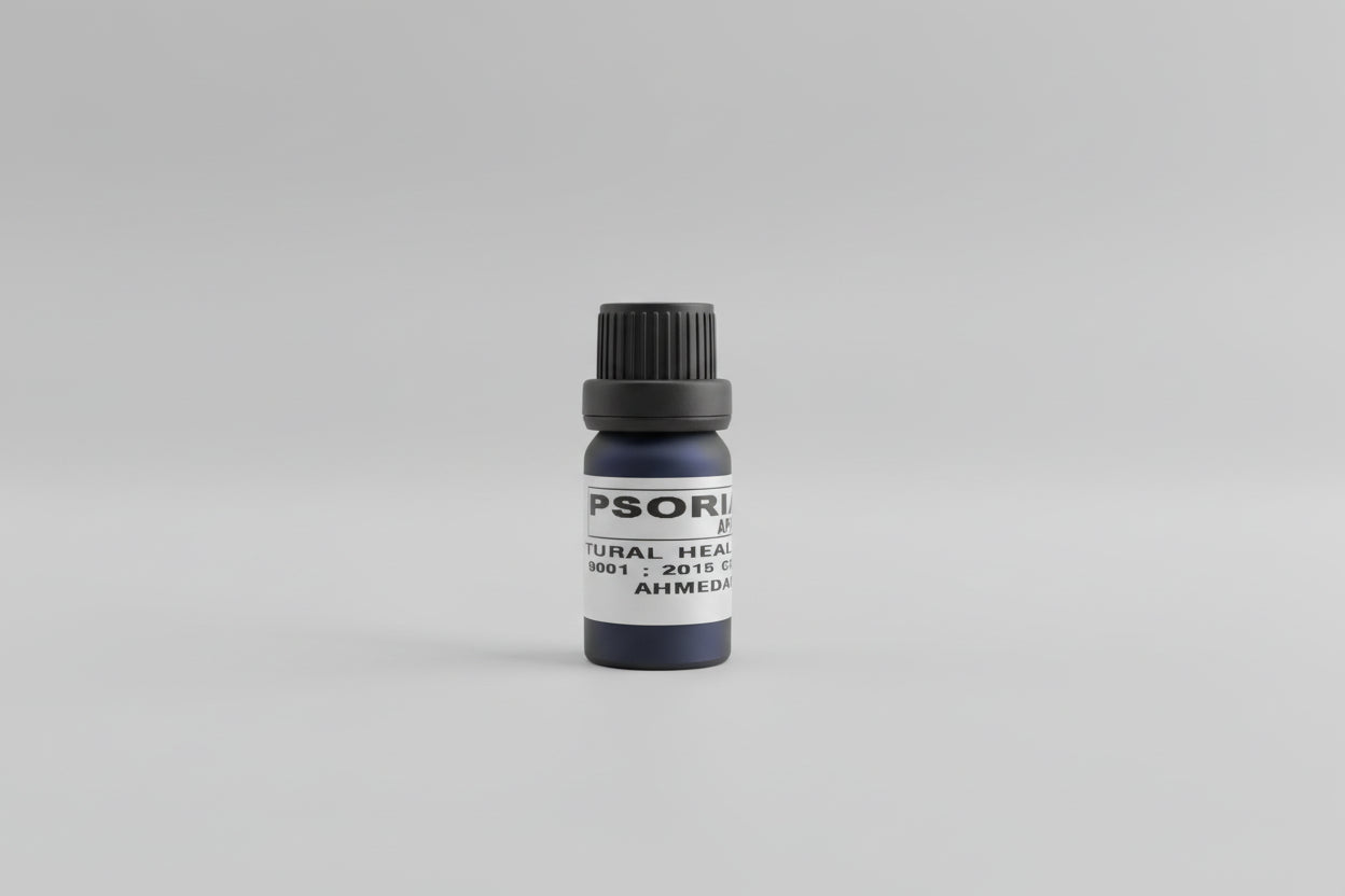 A small bottle labeled 'Psoriasis oil' held in a person's hand.