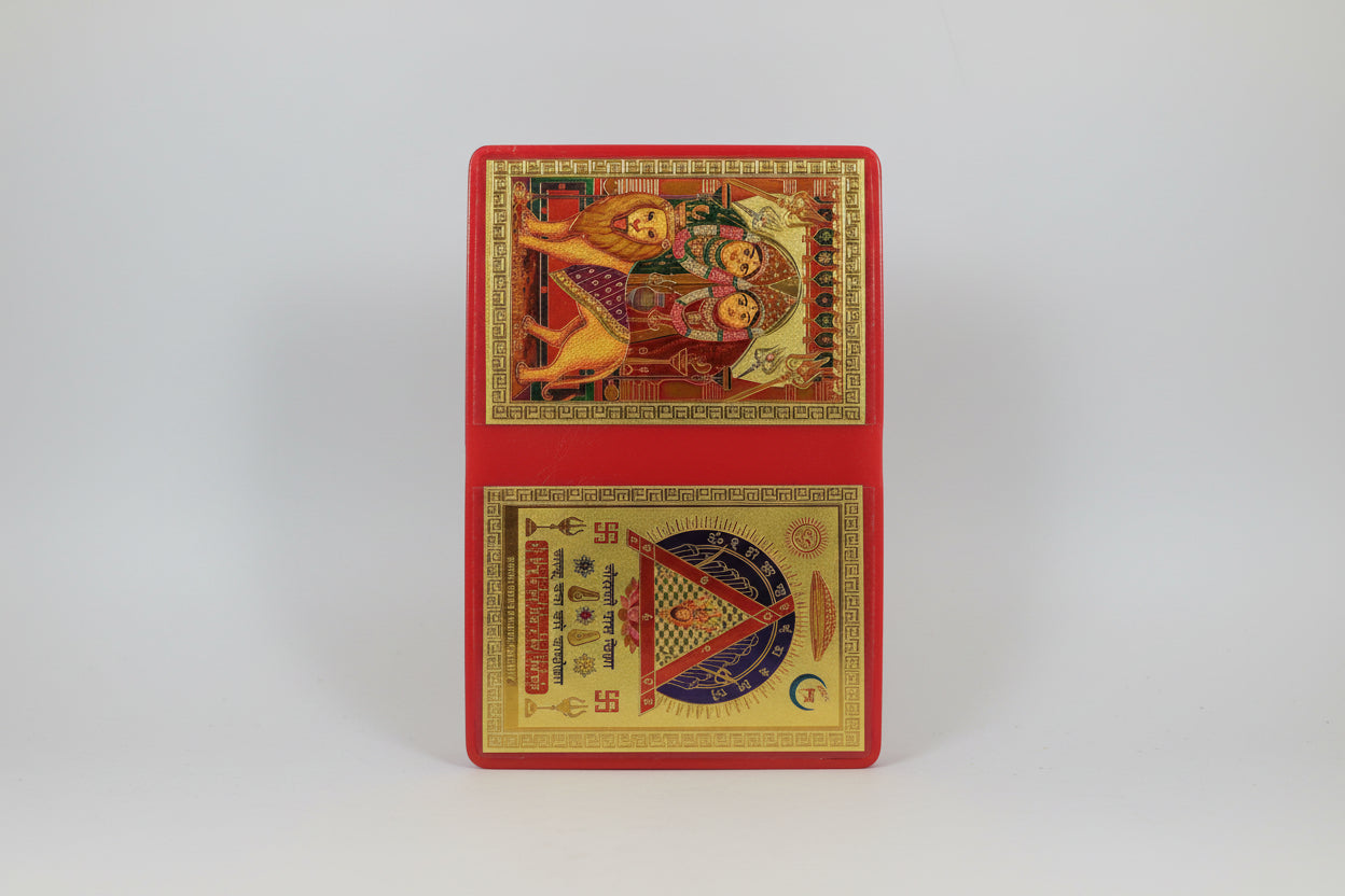 A Yantra or spiritual diagram in red and gold colors, with decorative elements and text, likely used for a religious or spiritual purpose.